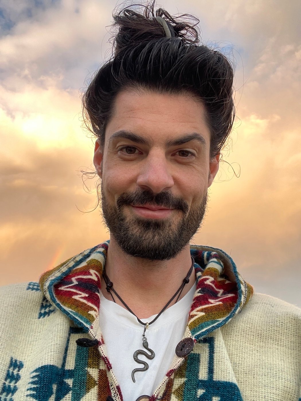 Immanuel Holtmannspoetter smiling warmly under an open evening sky