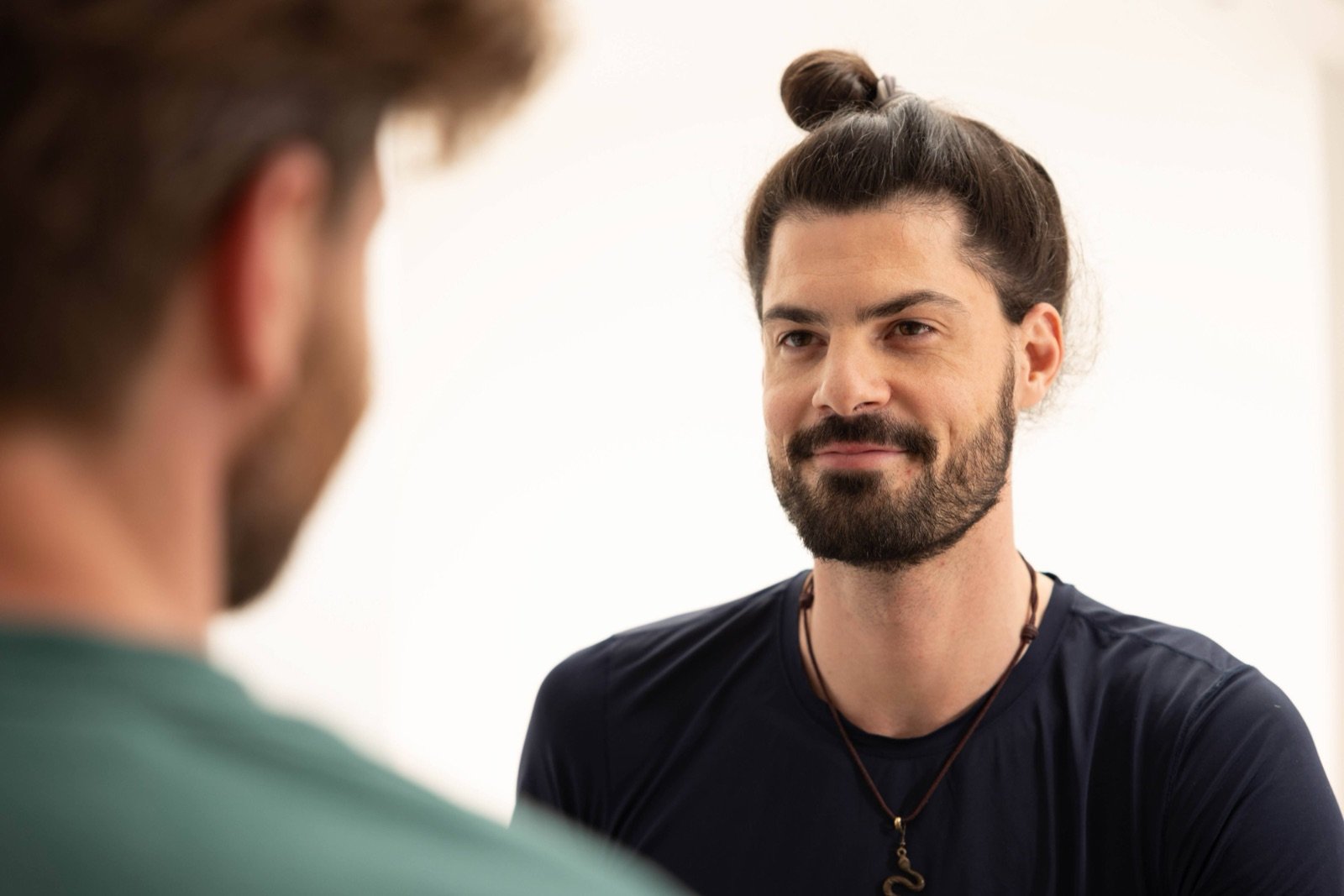 Immanuel in warm, attentive conversation with a client, listening face to face